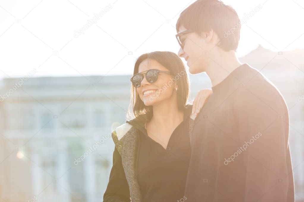 Happy young woman walking outdoors with her brother.
