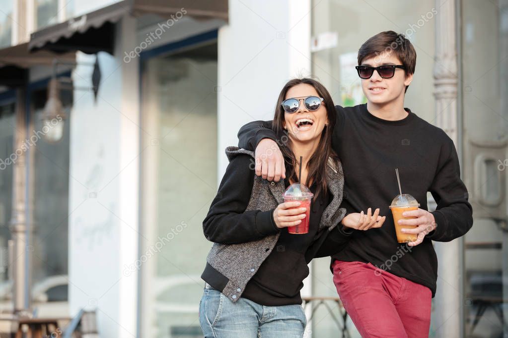 Smiling young lady walking outdoors with her brother