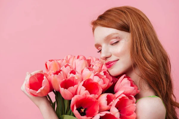 Young woman touching flowers — Stock Photo, Image