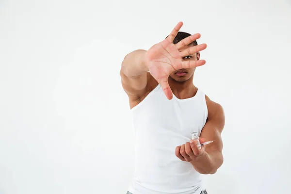 Young sportsman holding syringle close the camera — Stock Photo, Image