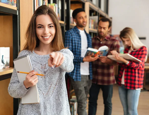 Sorrindo jovem estudante segurando livro didático — Fotografia de Stock