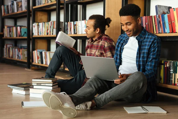 Young two african men students sitting in library — Stock Photo, Image