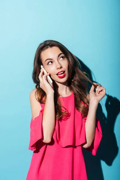 Girl in dress talking on mobile phone and looking away — Stock Photo, Image