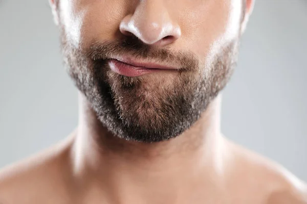 Cropped image of a doubtful bearded mans face — Stock Photo, Image