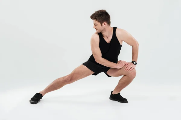 Portrait of a cheerful healthy man warming up before gym — Stock Photo, Image