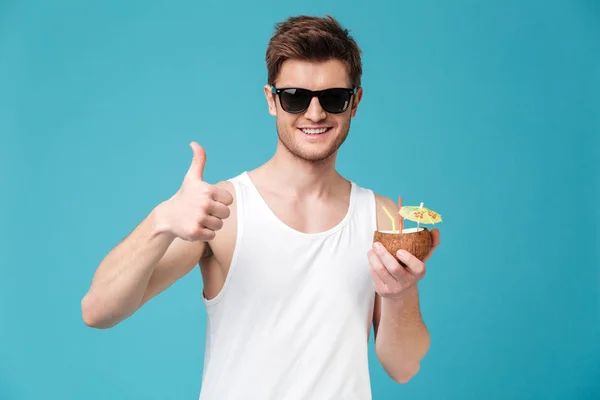 Happy man drinking cocktail and showing thumbs up. — Stock Photo, Image
