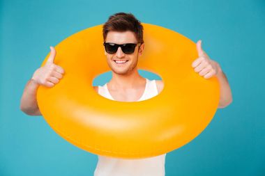 Guy in sunglasses holding inflatable ring aroung his neck clipart