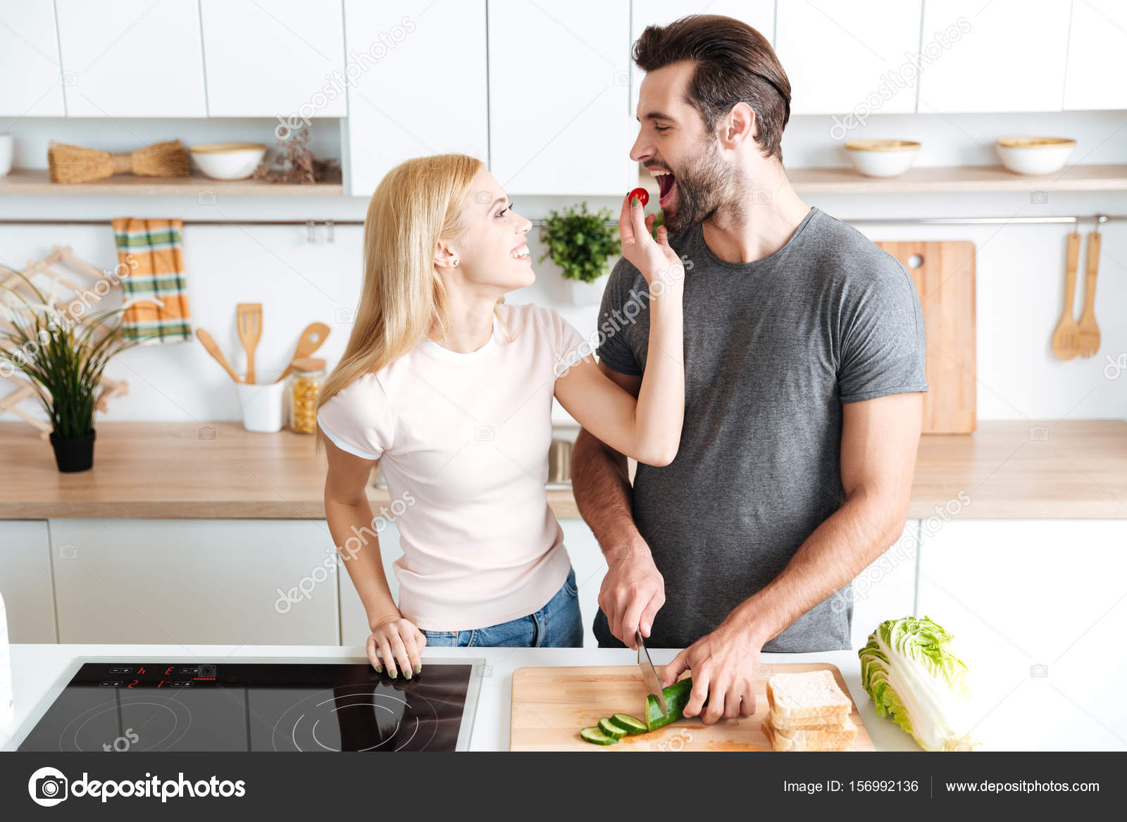 Romantic couple preparing dinner in the kitchen at home — Stock Photo