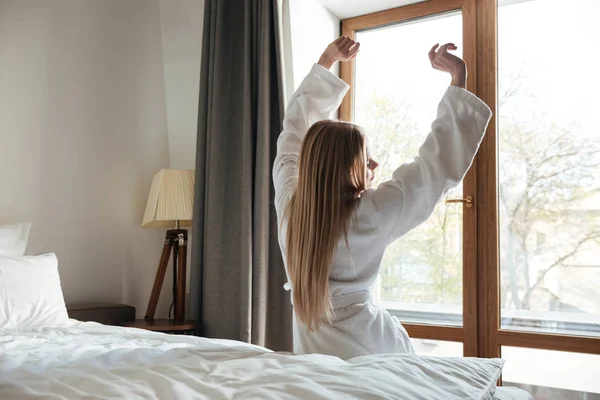 Hermosa mujer rubia estirando las manos por la mañana — Foto de Stock