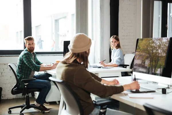 Colleagues work in office using computers. Looking aside. — Stock Photo, Image