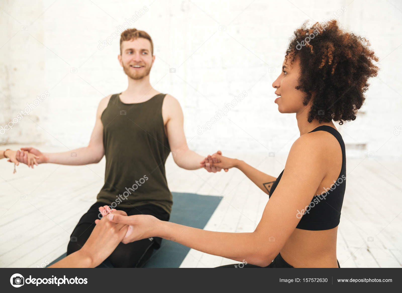 Male yoga instructor sitting in a circle Stock Photo by ©Vadymvdrobot