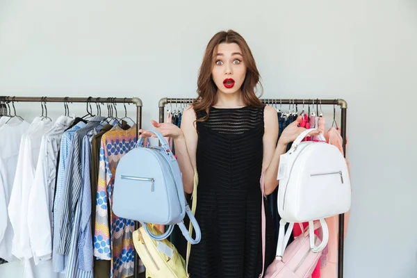 Vrouw kiezen tussen twee rugzakken. — Stockfoto