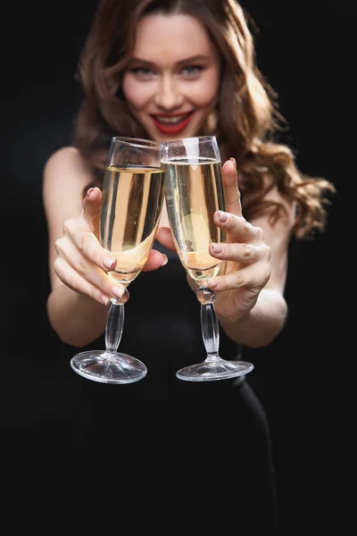 Smiling attractive young woman holding two glasses of champagne — Stock Photo, Image