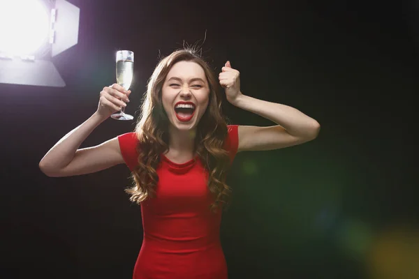 Feliz mulher animada com copo de champanhe de pé e gritando — Fotografia de Stock