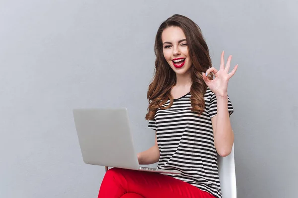Happy young lady showing ok gesture — Stock Photo, Image