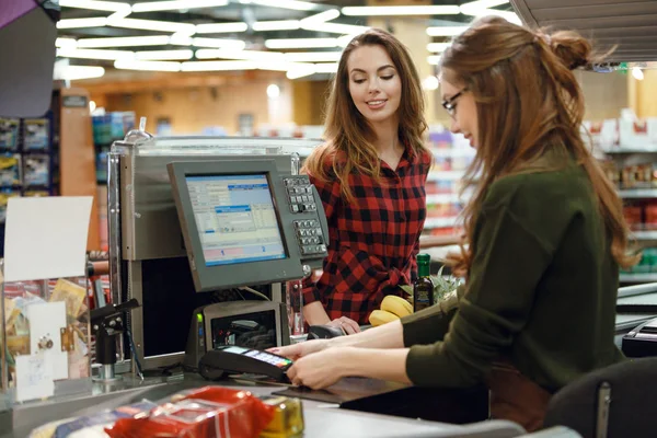 Mutlu genç bayan süpermarkette ayakta — Stok fotoğraf