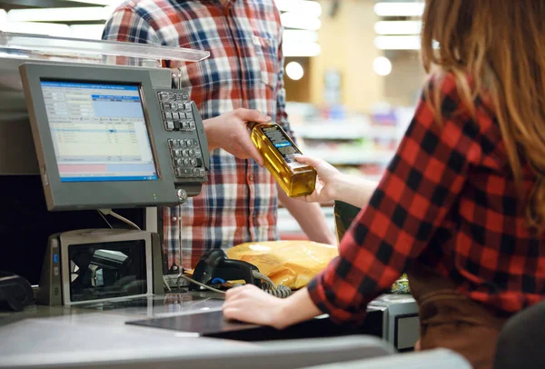 Man standing near cashier's desk in supermarket. — Stock Photo, Image