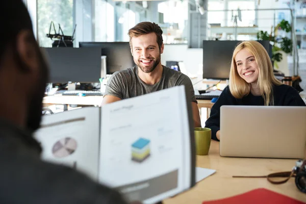 Happy young colleagues sitting in office coworking — Stock Photo, Image