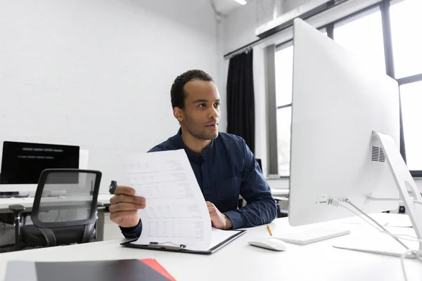 Young african business man sitting at his desk — Stock Photo, Image