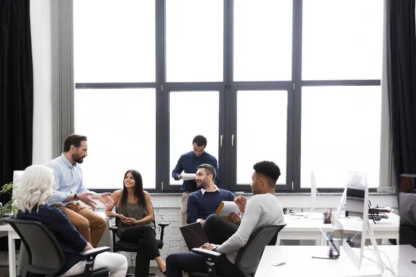 Young creative people sitting at the office — Stock Photo, Image