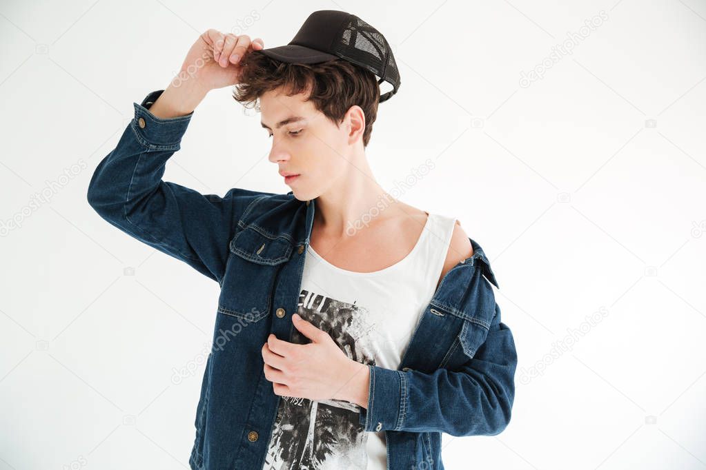 Young mystery man in cap and jeans jacket