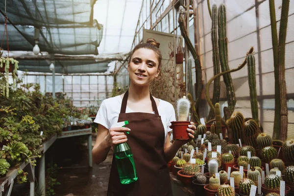 温室植物の近くに立って幸せな若い女 — ストック写真