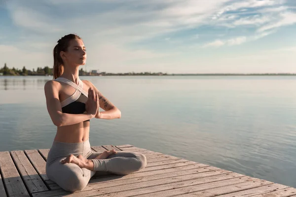 Joven deportista en la playa hacer ejercicios de meditación . —  Fotos de Stock