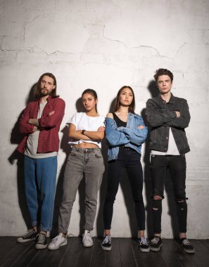 Ciddi hipsters gri arka plan üzerinde duran çiftler sevgi dolu