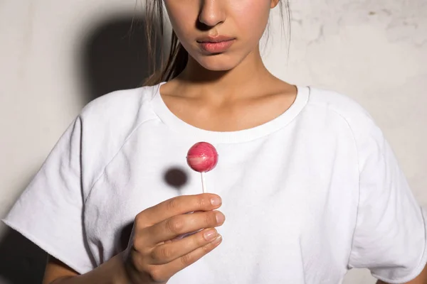 Imagen recortada de la joven mujer hipster sosteniendo dulces . — Foto de Stock