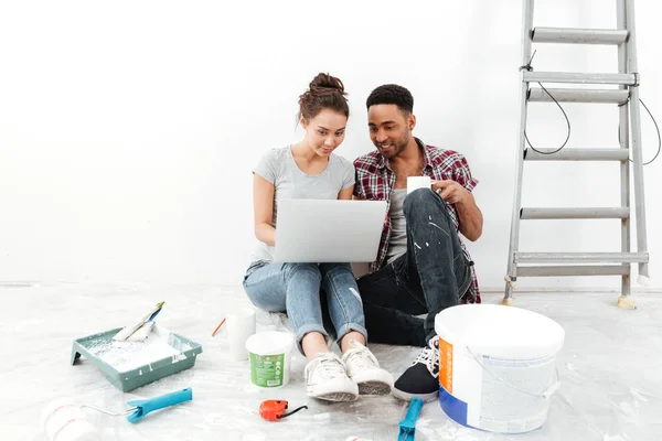 Feliz jovem casal amoroso sentado no chão em novo apartamento — Fotografia de Stock