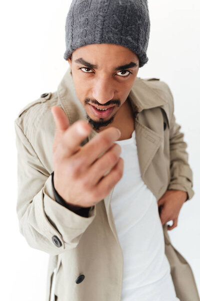 Handsome young african man pointing.