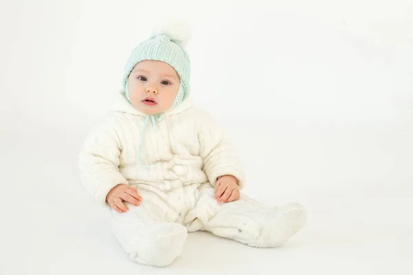 Cute little baby sitting on floor over white background — Stock Photo, Image