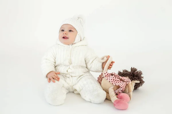 Cute little baby sitting on floor over white background — Stock Photo, Image