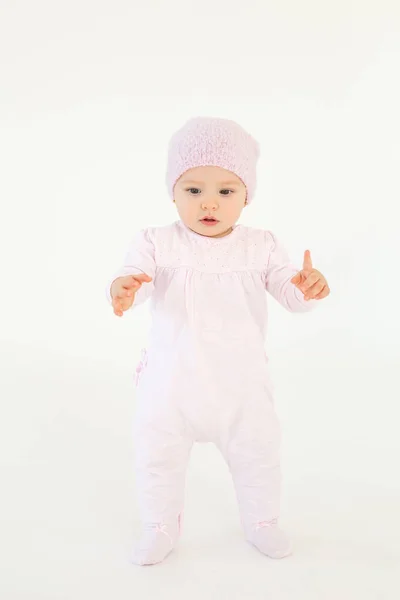 Cute little baby wearing hat standing on floor — Stock Photo, Image