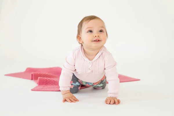 Pretty cute baby girl sitting on floor isolated — Stock Photo, Image