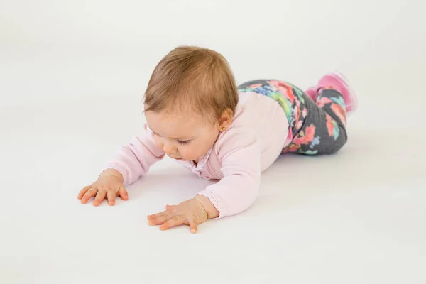Bayi perempuan lucu di lantai terisolasi di atas latar belakang putih — Stok Foto
