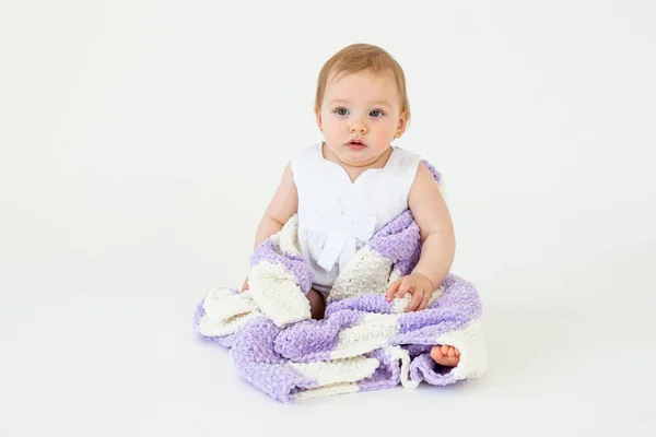 Pretty little baby girl sitting on floor with plaid isolated — Stock Photo, Image