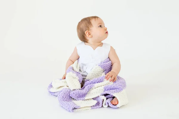 Pretty little baby girl sitting on floor with plaid isolated — Stock Photo, Image