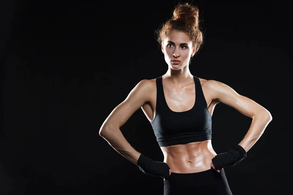 Serious female fighter holding arms on hips — Stock Photo, Image