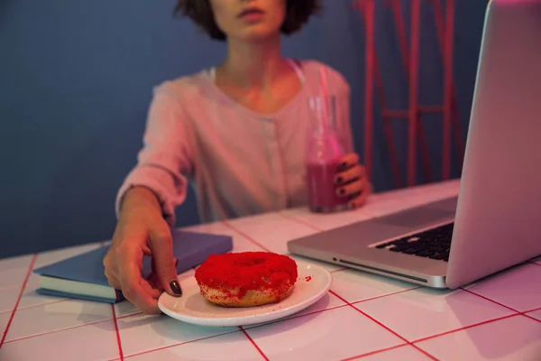 Imagem recortada de uma mulher tomando prato com um donut — Fotografia de Stock