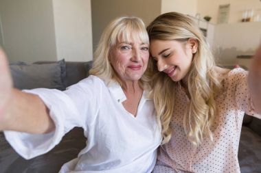 Gülümseyen genç torunu ve büyükannesi bir selfie alarak