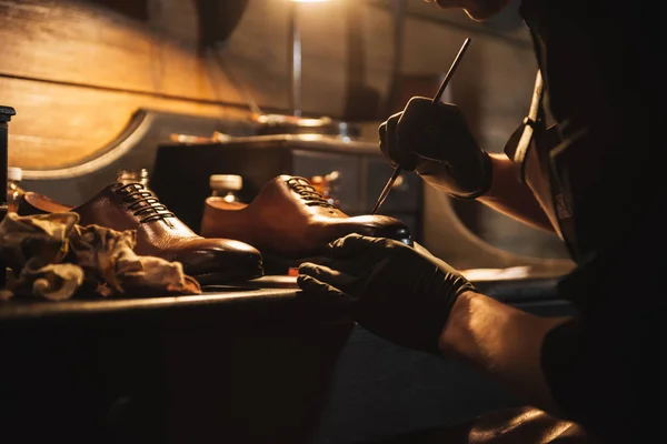 Cropped image of young concentrated man shoemaker — Stock Photo, Image