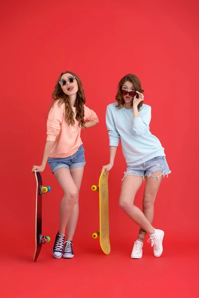 Happy twee dames vrienden houden skateboards. — Stockfoto