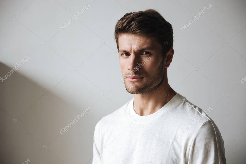 Sports man standing near grey wall outdoors