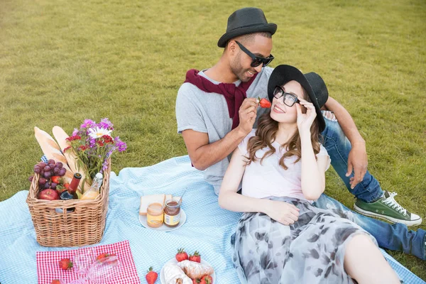 Tender young couple having picnic outdoors