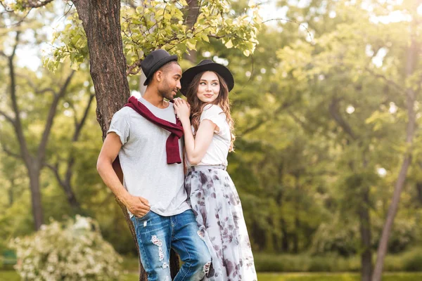 Beautiful young couple standing together in park — Stock Photo, Image
