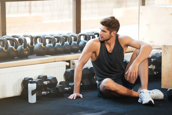 Fitness man sits on the floor — Stock Photo, Image