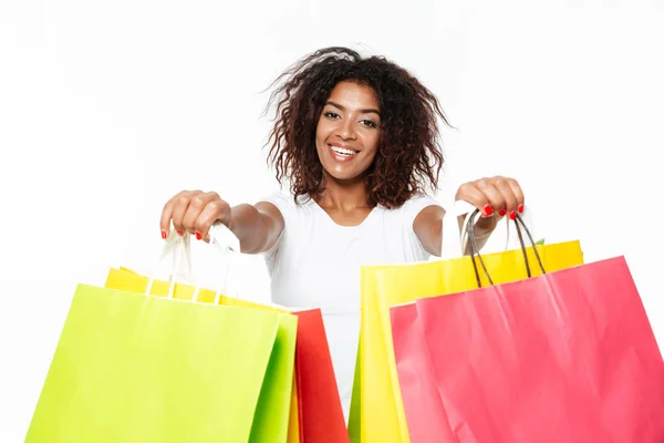 Happy young african woman holding shopping bags. — Stock Photo, Image