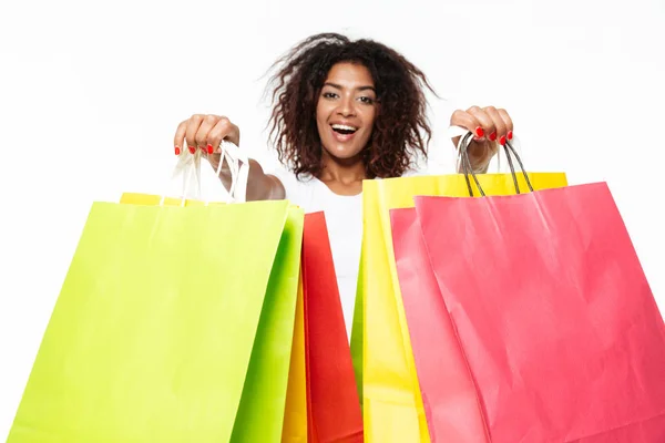 Happy young african woman holding shopping bags. — Stock Photo, Image