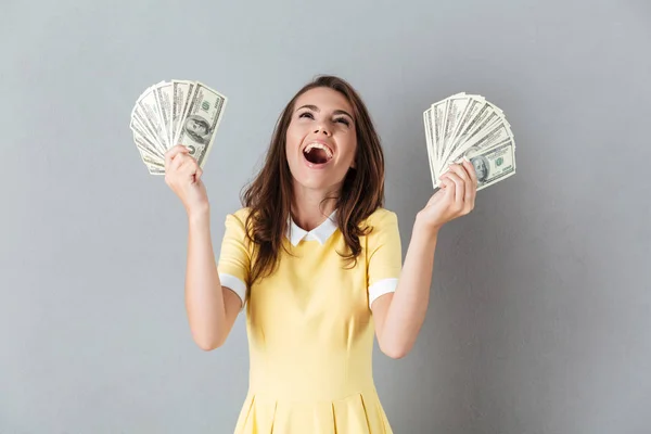 Amazing young caucasian lady holding money in hands — Stock Photo, Image